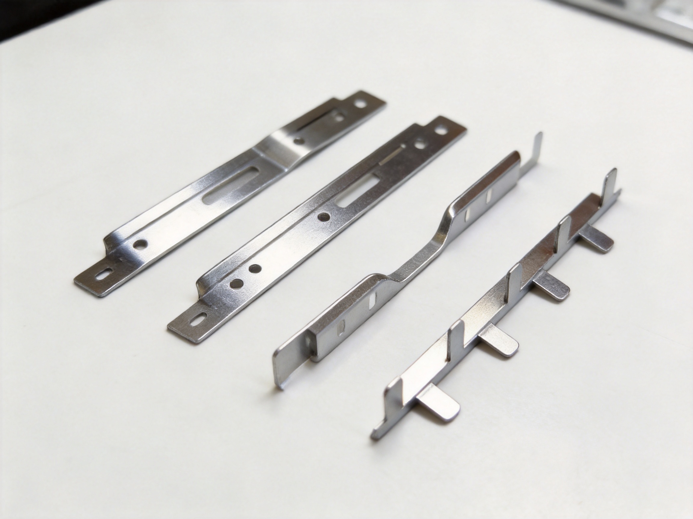 Stamped Bendable Strip-Shaped Parts for Precision Applications